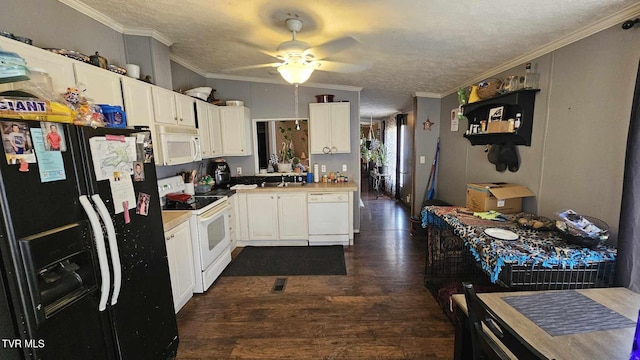 kitchen featuring dark wood-type flooring, white appliances, ornamental molding, and white cabinets