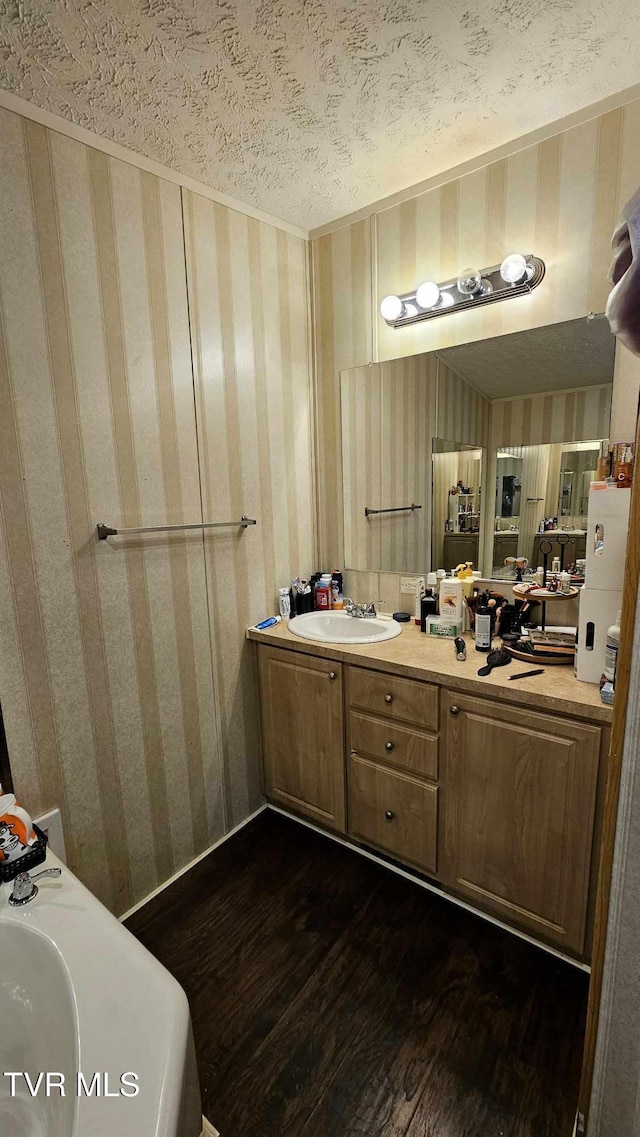 bathroom featuring wood-type flooring, a textured ceiling, and vanity