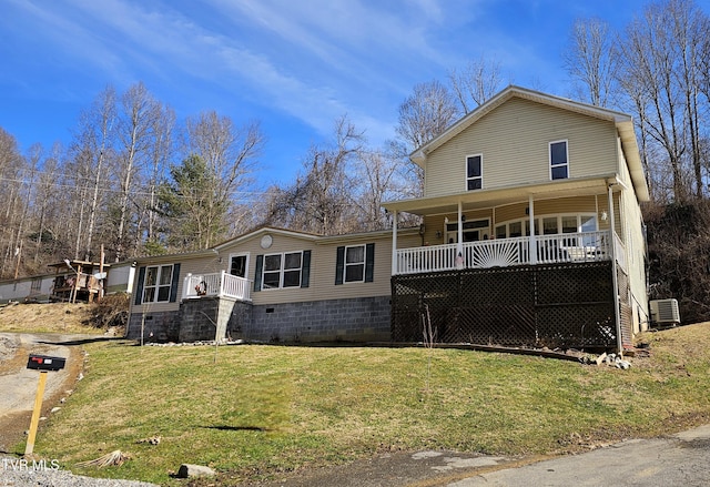 view of front of house with a porch, cooling unit, and a front lawn