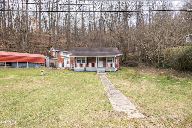 view of front of property with covered porch, a front lawn, and a carport