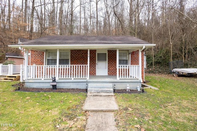 bungalow-style house with covered porch and a front lawn