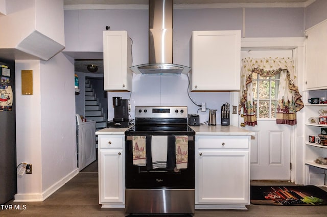 kitchen with electric stove, white cabinetry, wall chimney range hood, and washer / dryer