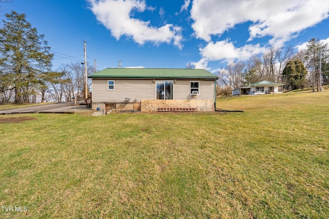 rear view of property with a lawn