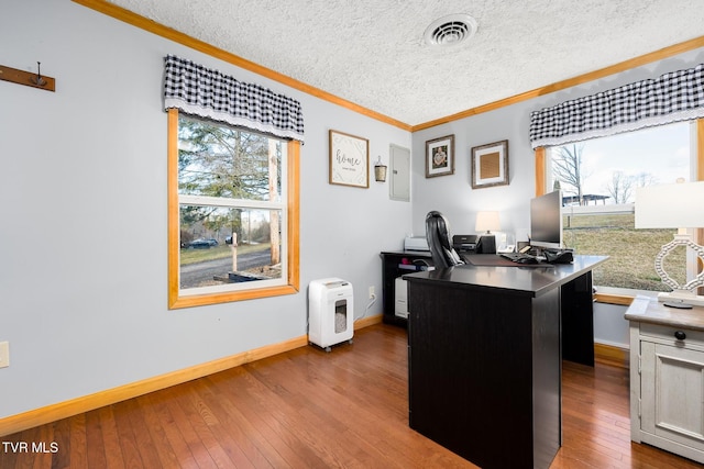 office area featuring crown molding, a wealth of natural light, a textured ceiling, and light wood-type flooring