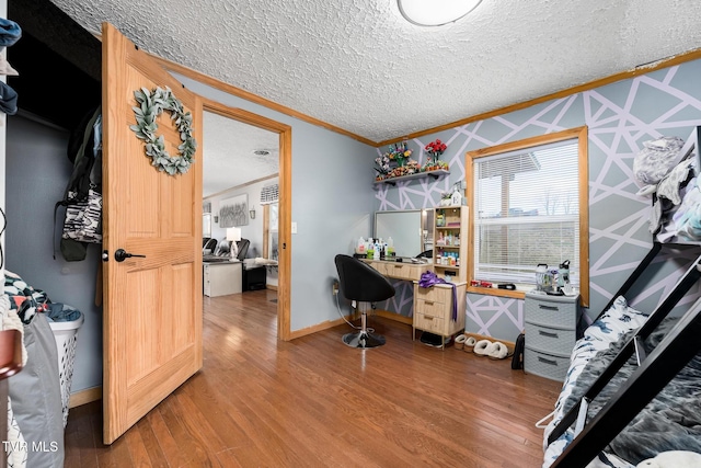 office space featuring crown molding, hardwood / wood-style floors, and a textured ceiling