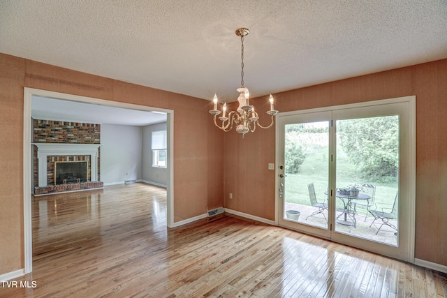 205 Donegal Way Unit 205, Bristol, TN 37620 - unfurnished dining area with a chandelier, a textured ceiling, visible vents, and wood finished floors