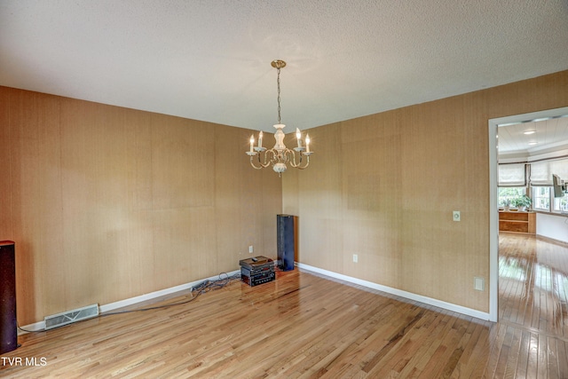 205 Donegal Way Unit 205, Bristol, TN 37620 - unfurnished dining area featuring an inviting chandelier, visible vents, baseboards, and hardwood / wood-style flooring