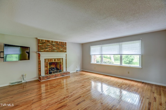 205 Donegal Way Unit 205, Bristol, TN 37620 - unfurnished living room featuring wood-type flooring, visible vents, and a textured ceiling