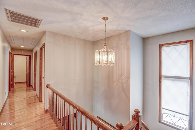 205 Donegal Way Unit 205, Bristol, TN 37620 - hallway featuring light wood-type flooring, an upstairs landing, attic access, and visible vents