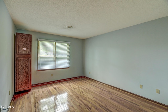 205 Donegal Way Unit 205, Bristol, TN 37620 - empty room featuring baseboards, visible vents, a textured ceiling, and wood finished floors