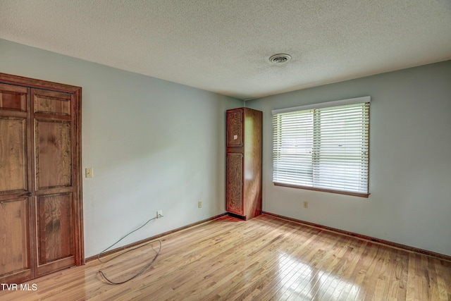 205 Donegal Way Unit 205, Bristol, TN 37620 - empty room featuring light wood finished floors, a textured ceiling, baseboards, and visible vents