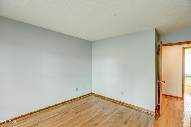 205 Donegal Way Unit 205, Bristol, TN 37620 - empty room featuring light wood finished floors, a textured ceiling, and baseboards