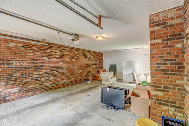 205 Donegal Way Unit 205, Bristol, TN 37620 - living room featuring concrete floors, a textured ceiling, a garage, and brick wall