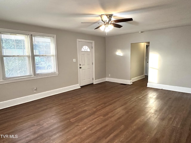 entryway with visible vents, a ceiling fan, baseboards, and dark wood-style flooring