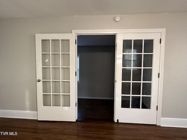 interior details with baseboards and wood finished floors