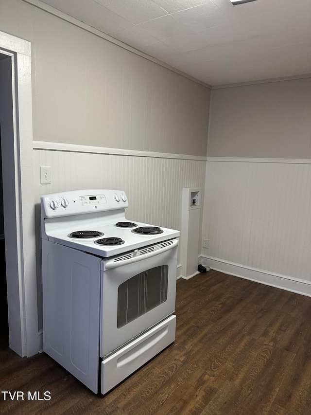 kitchen featuring white electric stove, dark wood-style floors, and wainscoting