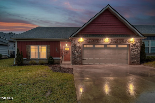 view of front of home featuring a garage and a yard