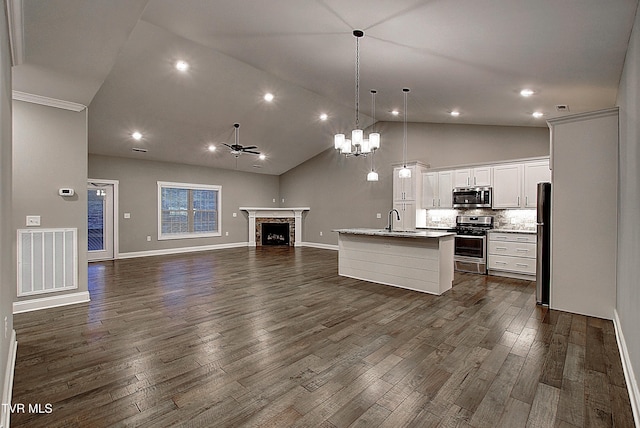 kitchen featuring sink, white cabinetry, appliances with stainless steel finishes, pendant lighting, and a kitchen island with sink