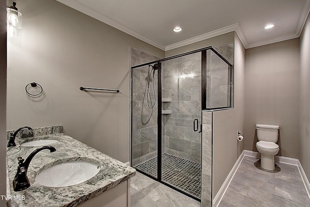 bathroom featuring crown molding, vanity, toilet, and a shower with door