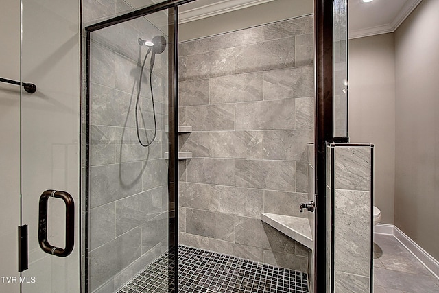 bathroom featuring a shower with door, ornamental molding, and toilet