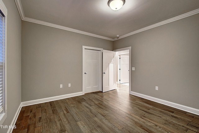 unfurnished bedroom with dark wood-type flooring and ornamental molding