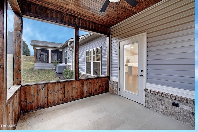 unfurnished sunroom featuring ceiling fan and wood ceiling