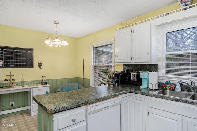 kitchen with decorative light fixtures, dishwasher, sink, white cabinets, and kitchen peninsula