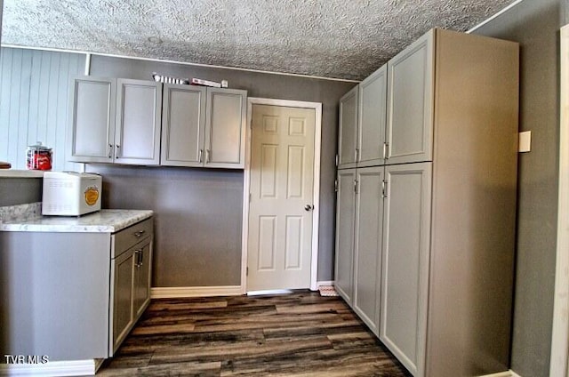 kitchen featuring dark hardwood / wood-style floors and a textured ceiling