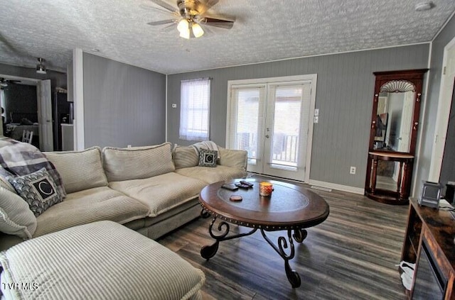 living room with a textured ceiling, ceiling fan, and french doors