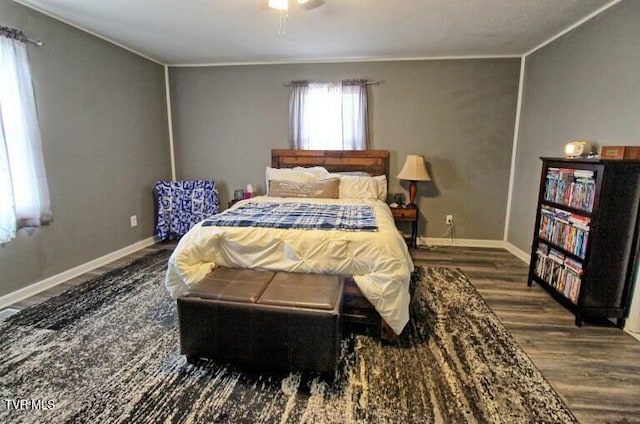 bedroom with dark hardwood / wood-style flooring and ceiling fan