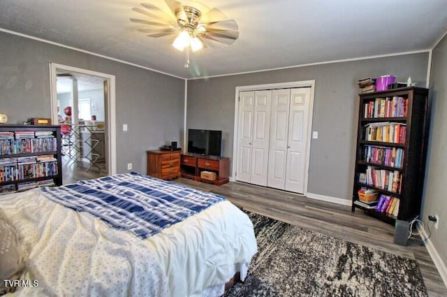 bedroom with dark hardwood / wood-style flooring, ornamental molding, and ceiling fan