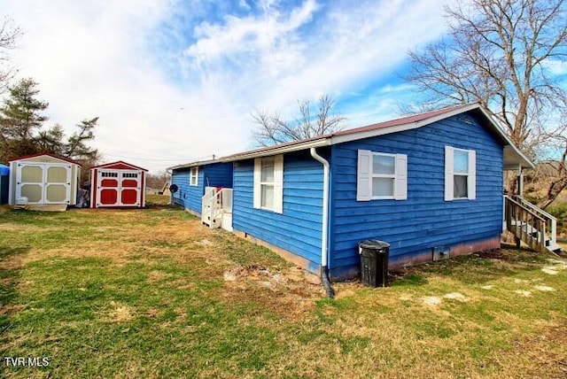 view of side of property featuring a storage unit and a yard