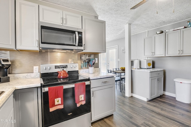 10955 Middle Wallens Creek Rd, Jonesville, VA 24263 - kitchen with stainless steel appliances, decorative backsplash, wood finished floors, and gray cabinets