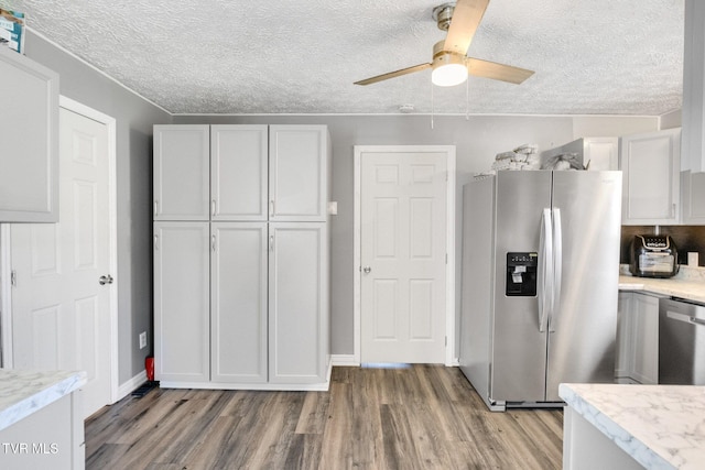 10955 Middle Wallens Creek Rd, Jonesville, VA 24263 - kitchen with ceiling fan, a textured ceiling, white cabinetry, stainless steel appliances, and light wood finished floors