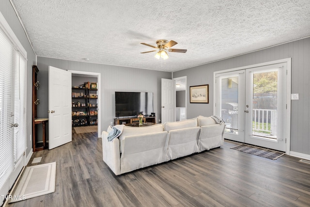 10955 Middle Wallens Creek Rd, Jonesville, VA 24263 - living room featuring a textured ceiling, a ceiling fan, wood finished floors, french doors, and baseboards