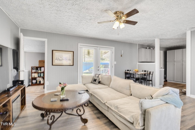 10955 Middle Wallens Creek Rd, Jonesville, VA 24263 - living area featuring french doors, a textured ceiling, a ceiling fan, and wood finished floors