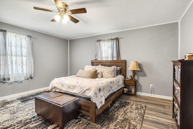 10955 Middle Wallens Creek Rd, Jonesville, VA 24263 - bedroom with multiple windows, baseboards, a ceiling fan, and wood finished floors