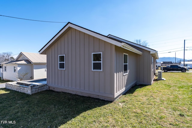 view of side of home featuring board and batten siding and a lawn