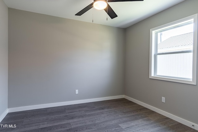 unfurnished room featuring dark wood-style floors, baseboards, and a ceiling fan