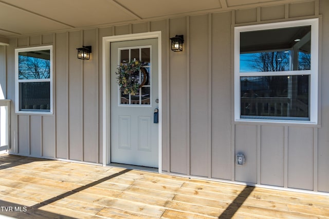 view of exterior entry featuring board and batten siding