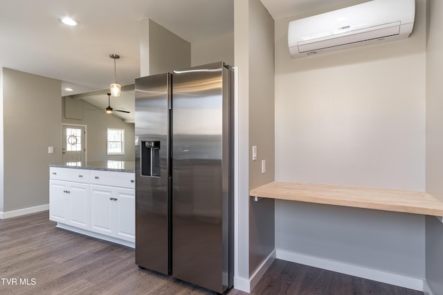 kitchen with wood counters, white cabinetry, a wall mounted AC, stainless steel refrigerator with ice dispenser, and dark wood finished floors