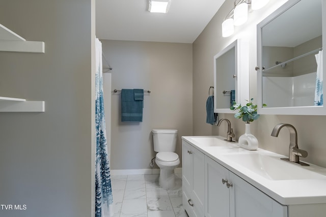 bathroom featuring marble finish floor, double vanity, a sink, and baseboards