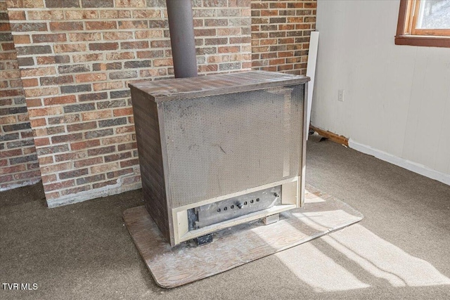 interior details with carpet floors, a wood stove, and baseboards