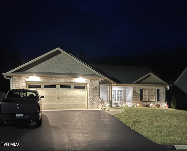 craftsman inspired home with a garage and a yard