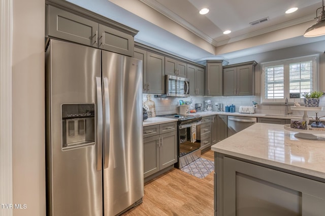 kitchen featuring crown molding, decorative backsplash, stainless steel appliances, and sink