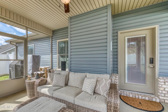 sunroom with a healthy amount of sunlight and wood ceiling