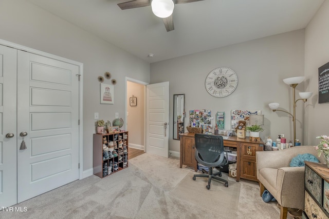 carpeted office space with ceiling fan