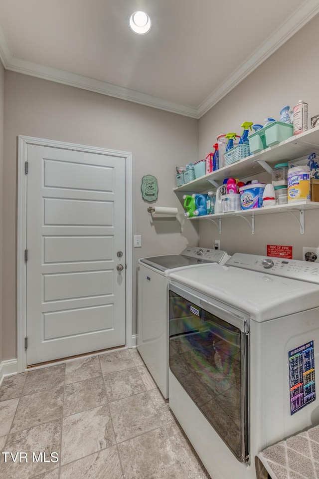 laundry room with crown molding and washer and clothes dryer