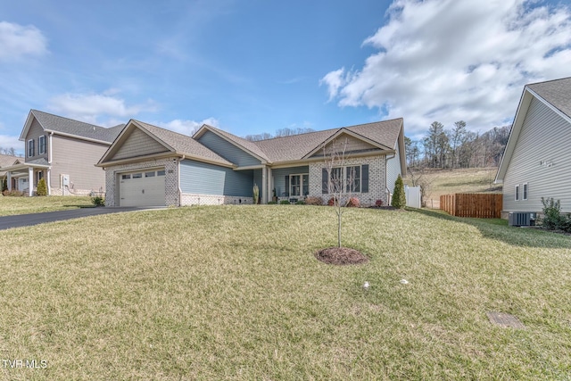 view of front of property with central AC unit, a garage, and a front yard