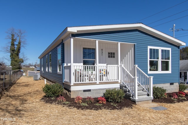 manufactured / mobile home with a porch, crawl space, fence, and central air condition unit